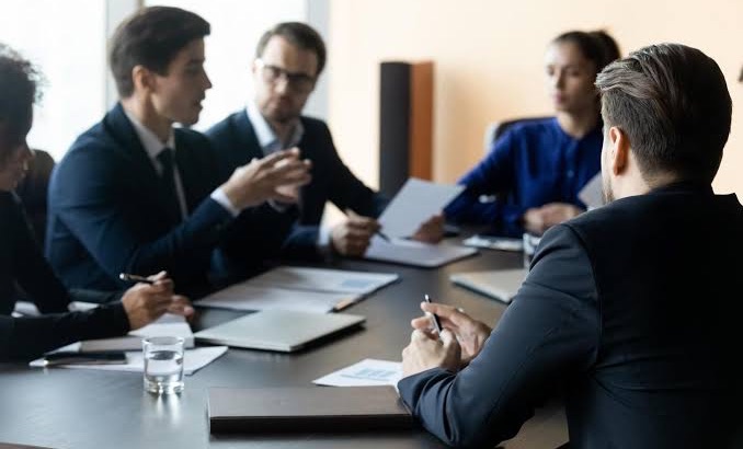 Fynalyse advisors in a client planning meeting reviewing financial reports