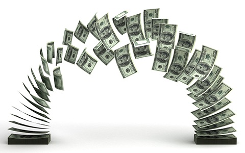 Banknotes arcing between two stacks, representing cash moving in and out