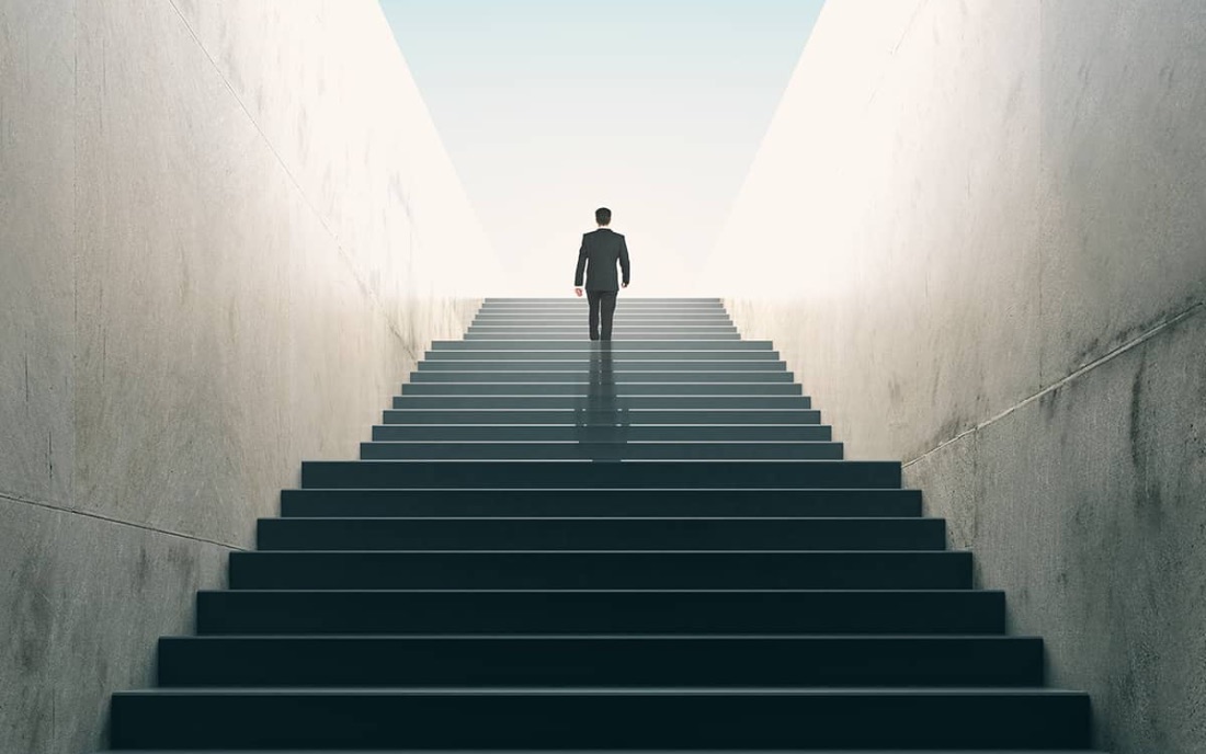 Executive climbing a staircase, representing senior financial leadership
